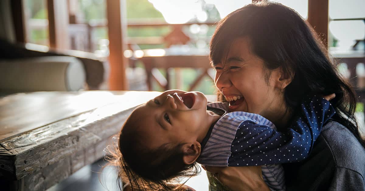 Mother playing and laughing with daughter